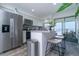 Bright kitchen featuring stainless steel appliances, white cabinetry, and an island with seating overlooking a waterfront view at 5041 N Beach Rd # 3A And 3B, Englewood, FL 34223