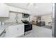Open layout featuring a well-equipped kitchen leading to the living area at 5041 N Beach Rd # 3A And 3B, Englewood, FL 34223