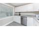 Bright kitchen with stainless steel dishwasher and ample storage at 5041 N Beach Rd # 3A And 3B, Englewood, FL 34223