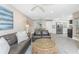 Cozy living room featuring a large leather sofa, woven coffee table, and open layout at 5041 N Beach Rd # 3A And 3B, Englewood, FL 34223