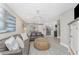 Cozy living room with modern decor, a large leather sofa, and a view of the kitchen and dining area at 5041 N Beach Rd # 3A And 3B, Englewood, FL 34223