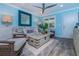 A comfortable coastal-themed living room with stylish decor, seating and a ceiling fan at 5041 N Beach Rd # 3A And 3B, Englewood, FL 34223