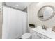 Bathroom with white vanity, shower with white curtain and decorative mirror at 5041 N Beach Rd # 4A And 4B, Englewood, FL 34223