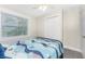Inviting bedroom with nautical bedding, window and closet with a ceiling fan at 5041 N Beach Rd # 4A And 4B, Englewood, FL 34223