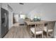 Dining area view opens to living area, features stainless steel refrigerator and wood floors at 5041 N Beach Rd # 4A And 4B, Englewood, FL 34223