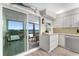 Bright kitchen features white cabinets and stainless steel appliances, and a water view from the balcony at 5041 N Beach Rd # 4A And 4B, Englewood, FL 34223