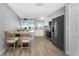 Stylish kitchen featuring stainless steel appliances, white cabinetry, and an adjacent dining area at 5041 N Beach Rd # 4A And 4B, Englewood, FL 34223