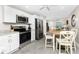Bright kitchen with stainless steel appliances and gray tile flooring at 5041 N Beach Rd # 4A And 4B, Englewood, FL 34223