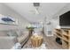 Open-concept living room with neutral colors, stylish accents, and seamless flow to dining area at 5041 N Beach Rd # 4A And 4B, Englewood, FL 34223