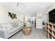 Open floor plan of a living room leading to the kitchen and the bedroom at 5041 N Beach Rd # 4A And 4B, Englewood, FL 34223
