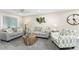 Living room with two gray couches, a patterned chair, and stylish decor at 5041 N Beach Rd # 4A And 4B, Englewood, FL 34223