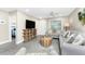 Bright living room with open access to the bedroom and neutral walls at 5041 N Beach Rd # 4A And 4B, Englewood, FL 34223