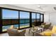 Enclosed sun room with water views and comfortable seating arrangement at 5041 N Beach Rd # 4A And 4B, Englewood, FL 34223