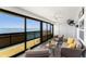 Relaxing sunroom features walls of windows with stunning water views and comfortable seating at 5041 N Beach Rd # 4A And 4B, Englewood, FL 34223