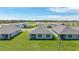 An aerial view showcases homes with well-manicured lawns in a serene community setting with a lake at 5132 Schubert Trl, North Port, FL 34287