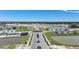Suburban community featuring new homes surrounding a roundabout and ponds in a Gathering-friendly area at 5132 Schubert Trl, North Port, FL 34287