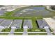 A scenic aerial view captures modern homes near a tranquil lake, showcasing community charm at 5132 Schubert Trl, North Port, FL 34287