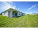 A spacious backyard boasts a well-maintained lawn, ideal for relaxation and outdoor activities at 5132 Schubert Trl, North Port, FL 34287