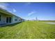 Expansive backyard featuring lush green grass extending from the covered patio, perfect for outdoor enjoyment at 5132 Schubert Trl, North Port, FL 34287
