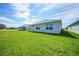 The exterior view features a well-kept lawn and a covered patio, perfect for outdoor relaxation at 5132 Schubert Trl, North Port, FL 34287