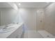 Well-lit bathroom showcases double sinks, a walk-in shower with tile surround, and neutral finishes at 5132 Schubert Trl, North Port, FL 34287