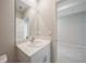 A bright bathroom featuring a modern vanity with a white countertop and view into the next room at 5132 Schubert Trl, North Port, FL 34287