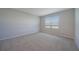 Bright bedroom featuring neutral carpet, natural light, and a window with backyard views at 5132 Schubert Trl, North Port, FL 34287