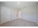 Neutral bedroom featuring two doors, and an opening with carpeted floors at 5132 Schubert Trl, North Port, FL 34287