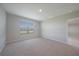 Bright bedroom featuring neutral carpet, natural light, and a window with outdoor views at 5132 Schubert Trl, North Port, FL 34287