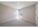 A bright bedroom with neutral walls and carpet, featuring a window with blinds for natural light at 5132 Schubert Trl, North Port, FL 34287