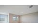 Bright bedroom with a large window overlooking a lake view and neutral walls at 5132 Schubert Trl, North Port, FL 34287