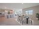 Stylish dining area with modern table set, adjacent to a bright living area with views at 5132 Schubert Trl, North Port, FL 34287