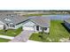A charming home boasts a manicured lawn and inviting brick driveway, enhancing its curb appeal at 5132 Schubert Trl, North Port, FL 34287