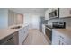Modern kitchen showcasing stainless steel appliances, white cabinets, and sleek countertops at 5132 Schubert Trl, North Port, FL 34287