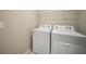 Bright laundry area featuring a Whirlpool washer and dryer set and an overhead rack at 5132 Schubert Trl, North Port, FL 34287