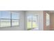 Bright living room with a sliding glass door and large window offering picturesque outdoor views at 5132 Schubert Trl, North Port, FL 34287