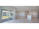 Bright open concept floorplan featuring a living room and kitchen with sliding door access to the backyard at 5132 Schubert Trl, North Port, FL 34287
