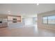Bright, open-concept living room featuring tile floors, recessed lighting, and a modern kitchen with stainless steel appliances at 5132 Schubert Trl, North Port, FL 34287