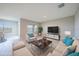Staged living room featuring a comfortable sofa, armchairs, and views of a backyard at 5132 Schubert Trl, North Port, FL 34287