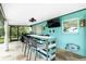 A fun outdoor bar area with seating, a television, and a vibrant atmosphere at 52 Golfview Ter, Rotonda West, FL 33947