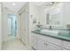 Bathroom with a white vanity, square sink, decorative mirror, and tiled floor at 52 Golfview Ter, Rotonda West, FL 33947
