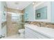 Bright bathroom featuring a glass shower, modern vanity, and decorative tile accents at 52 Golfview Ter, Rotonda West, FL 33947