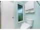 Modern bathroom with a sleek toilet, updated fixtures, and a frosted window providing natural light and privacy at 52 Golfview Ter, Rotonda West, FL 33947