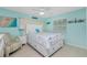 Coastal bedroom design with white furniture and a starfish themed bedspread at 52 Golfview Ter, Rotonda West, FL 33947