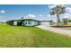Inviting home with a lush green lawn and an attached two-car garage at 52 Golfview Ter, Rotonda West, FL 33947