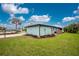 Charming single-story home with well-maintained lawn and tropical landscaping on a sunny day at 52 Golfview Ter, Rotonda West, FL 33947