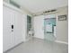Bright foyer with light tile flooring, sliding barn door to bedroom, and coastal decor at 52 Golfview Ter, Rotonda West, FL 33947