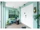 Inviting front porch with decor, double front door, plants and a large window at 52 Golfview Ter, Rotonda West, FL 33947