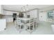 Bright open kitchen with large island, stainless steel appliances, and white cabinetry at 52 Golfview Ter, Rotonda West, FL 33947