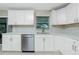 Modern kitchen design features stainless steel dishwasher and ample counter space with stylish cabinetry at 52 Golfview Ter, Rotonda West, FL 33947